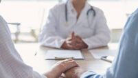 Mature couple holding hands at a doctors office
