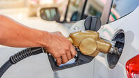 Hand refilling the car with fuel at the gasoline station
