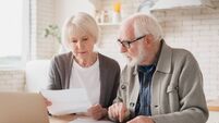 Serious caucasian old elderly senior couple grandparents family counting funds on calculator, doing paperwork, savings, paying d