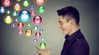man using smartphone with social media application icons