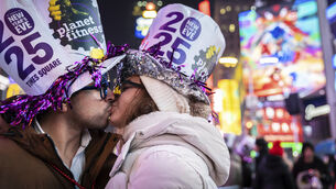 <p>A couple kiss after the ball drops in New York’s Times Square. Picture: AP/Stefan Jeremiah</p>