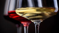 Three glass of red, rose and white wine over black background. Wine card menu design. Closeup of wineglasses with luxury wines f