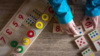 Child playing with mathematical toy
