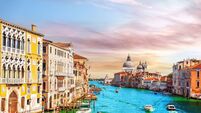 Gondolas and boats in the Grand Canal of Venice near Santa Maria della Salute, Italy