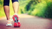 Young fitness female runner legs ready for run on forest trail