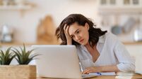 Young woman studying and having a head ache