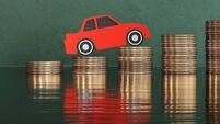 Red paper cutout car on stacks of gold coins on green background. Illustration of the concept of increasing car prices, surging