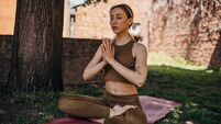 Woman meditating in back yard