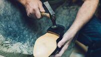 Unrecognizable Shoemaker At Work.