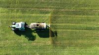 Drone image of a tractor spreading liquid manure or slurry on a field