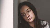 Depressed teenager sitting lonely