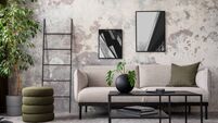 Indiustral composition of concrete living room with mock up poster frame, stylish grey sofa, green pillow, black coffee table, p