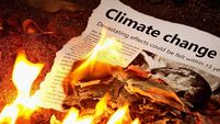 "Climate change" headline in flaming newspaper