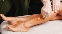 Close up photo of a sugaring procedure done at the salon during a leg skin protection session