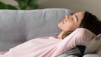 Side close up view woman having day nap on couch
