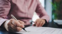 businesswoman signing an official document