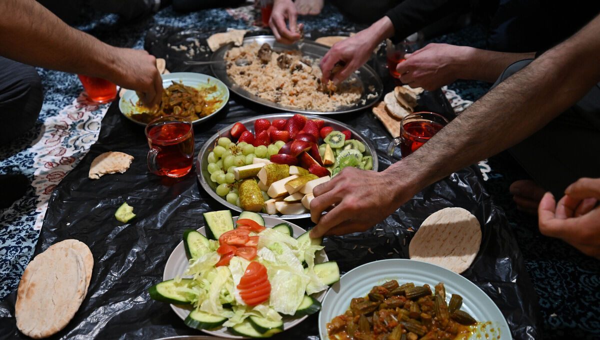 Breaking their fast, the men help themselves to the food they prepared. Picture: Ray Ryan Breaking their fast, the men help themselves to the food they prepared. Picture: Ray Ryan