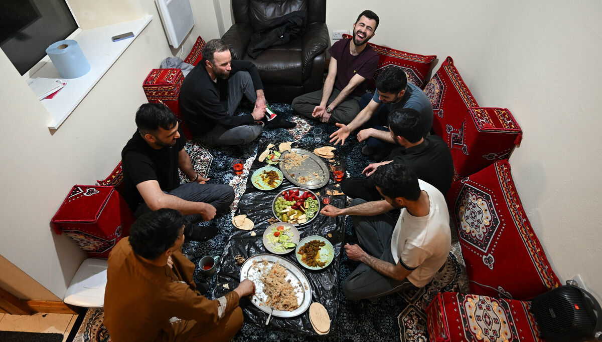 Colin Sheirdan, top left, shares food with in the men's home following sunset. Picture: Ray Ryan Colin Sheirdan, top left, shares food with in the men's home following sunset. Picture: Ray Ryan