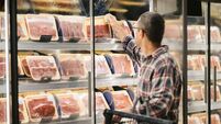 Man buying meat at grocery store
