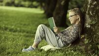 Eight-year-old girl enjoying a read in the open air