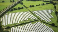 Aerial view over solar farm photovoltaic power station solar panels
