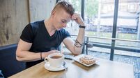Handsome young man on his phone in cafe