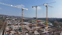 Building is live at the marquee site with first homes due in early 2027