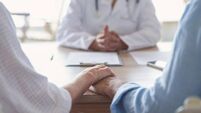 Mature couple holding hands at a doctors office