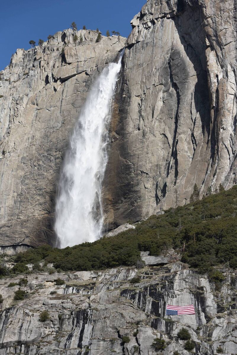 A US flag hanging upside down below the Upper Yosemite Falls during a protest against federal employee layoffs. The cuts were part of the work of the newly-created Department of Government Efficiency (DOGE), led by billionaire Elon Musk, as part of a declared effort to reduce public spending by dismantling the federal bureaucracy. Picture: Laure Andrillon / AFP A US flag hanging upside down below the Upper Yosemite Falls during a protest against federal employee layoffs. The cuts were part of the work of the newly-created Department of Government Efficiency (DOGE), led by billionaire Elon Musk, as part of a declared effort to reduce public spending by dismantling the federal bureaucracy. Picture: Laure Andrillon / AFP