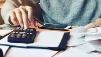 Man using calculator and calculate bills in home office.