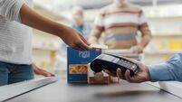 Woman paying with a credit card at the supermarket