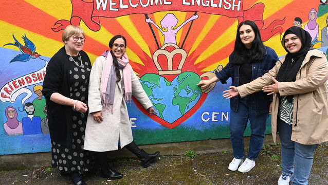 <p> Ann Bracken, volunteer tutor with students Karen, from Brazil; Nino from Georgia and Lima, from Afghanistan at the welcome mural at Welcome English Lanuage Centre. Picture: Larry Cummins</p>
