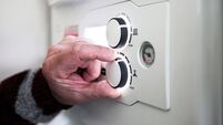 A pensioner adjusting the temperature control on his combi boiler. Redcar, UK. 26/5/2021. Photograph: Stuart Boulton.